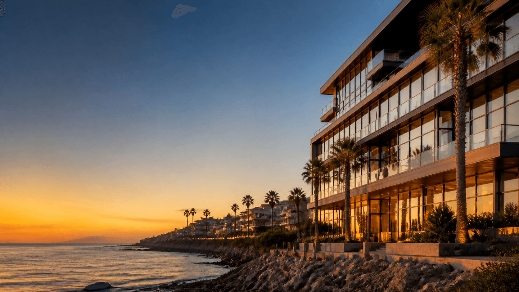 A coastal mixed-use building at sunset.